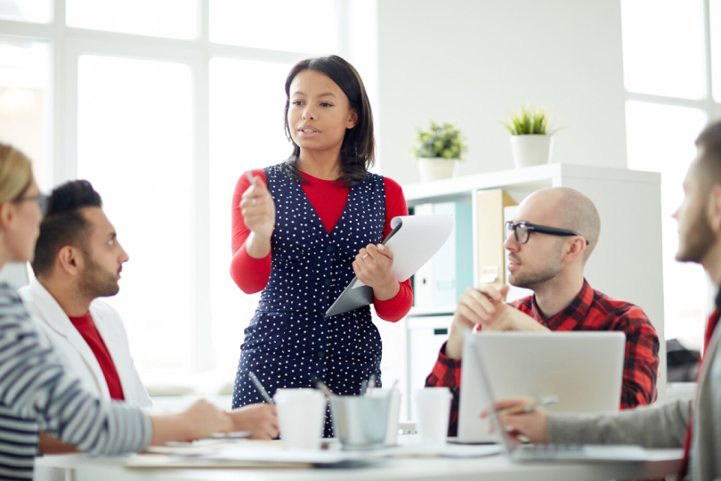 Corporate leader guiding a team through leadership coaching